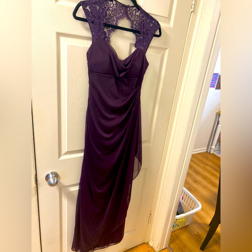 Long aubergine dress with lace detail.